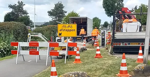 Afgezette weg met werkverkeer en pylonen bij een bouwlocatie